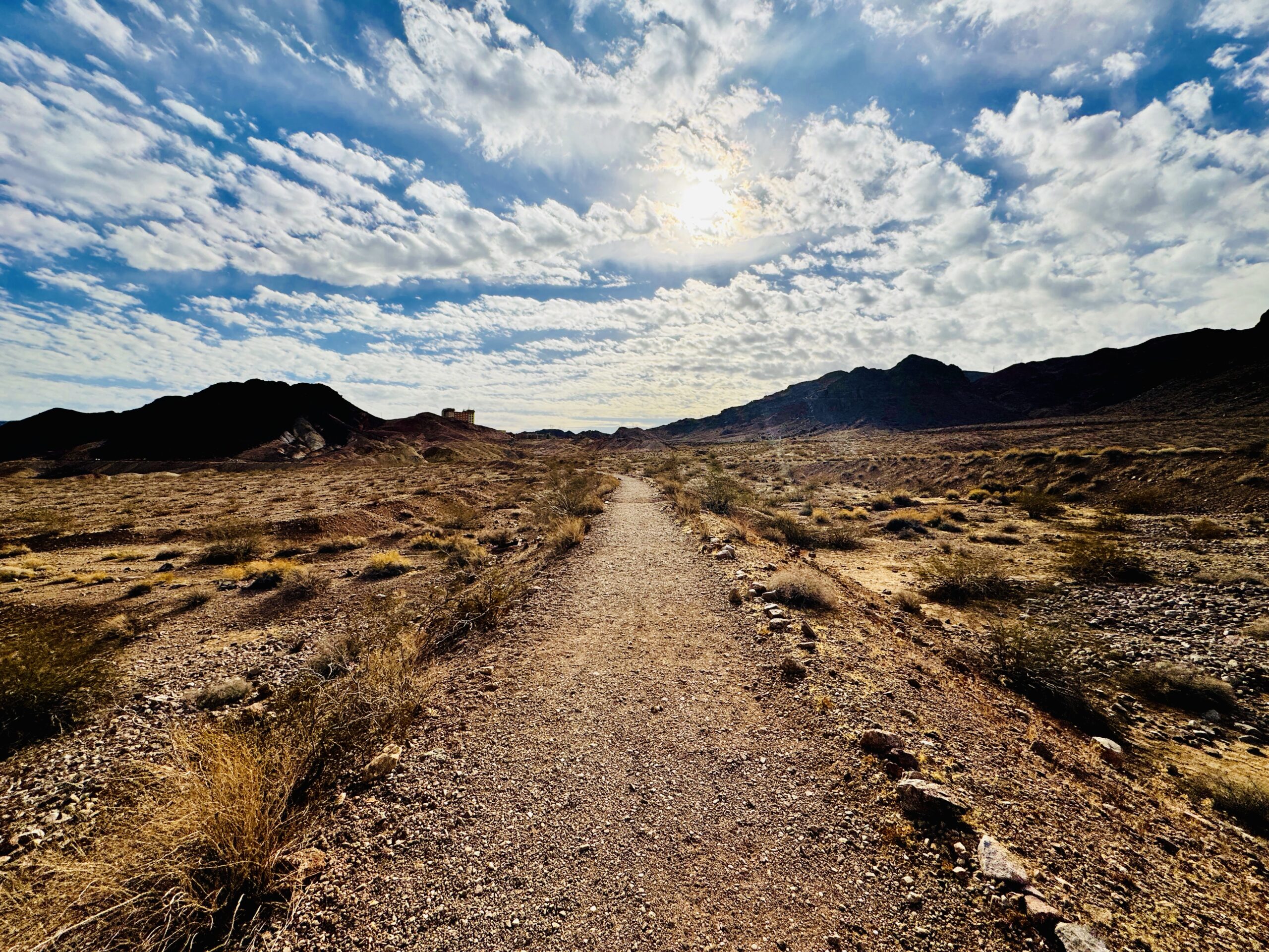 Wide desert trail beneath an open sky