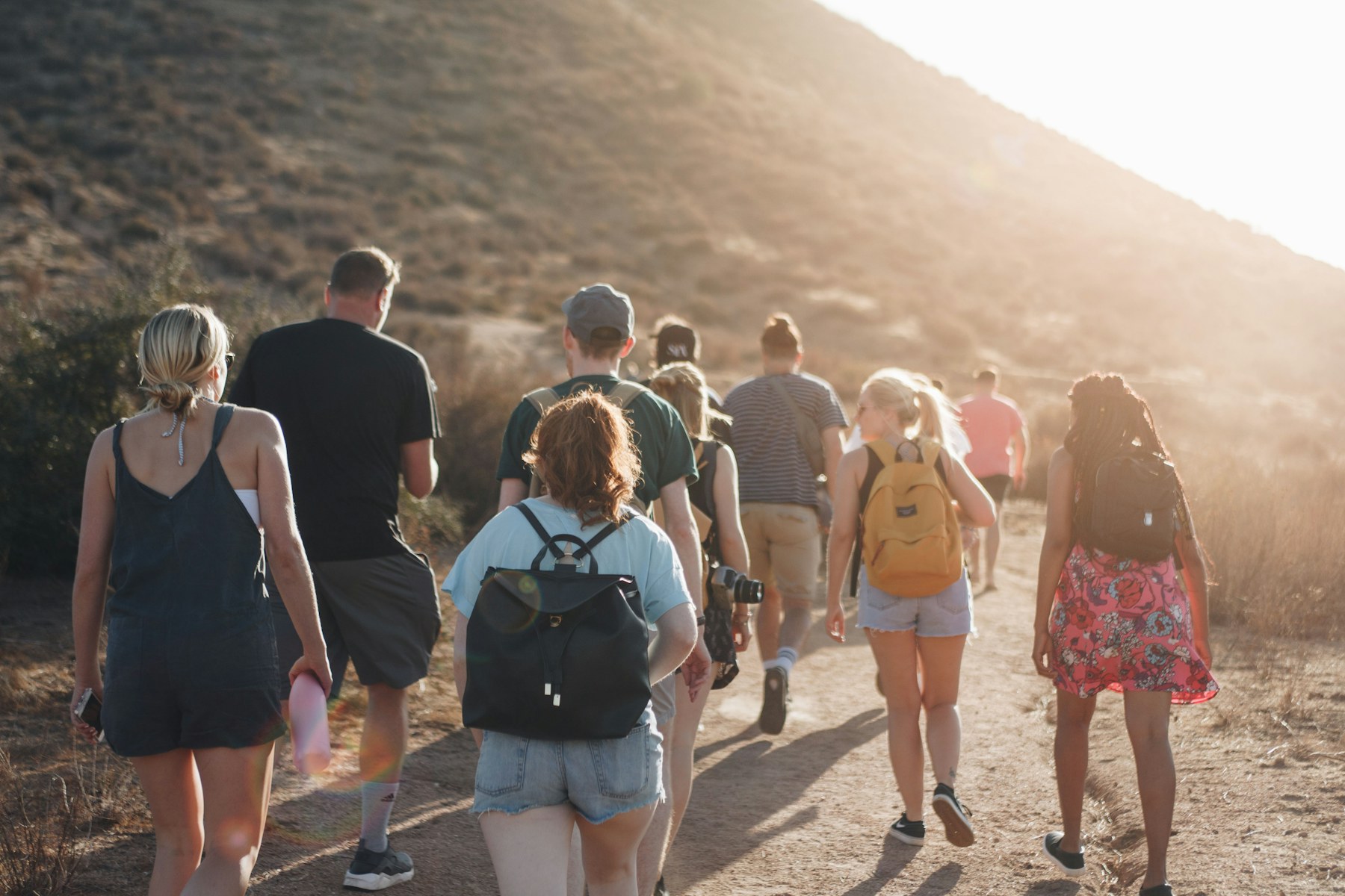 A diverse group of hikers walking together on a mountain trail